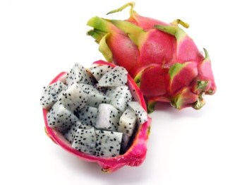 13187952 - diced dragon fruit pieces in the shell next to a whole fruit